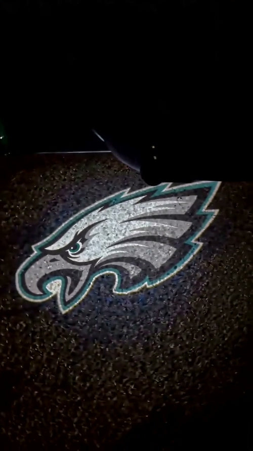 The Eagles logo projected onto the pavement the moment the door opens